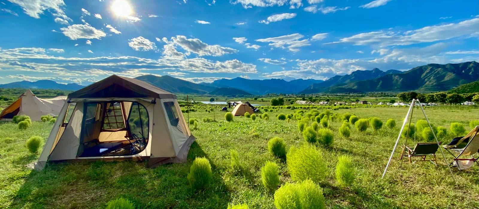 Campsite in a sunny mountain meadow, ready for a trailside meal